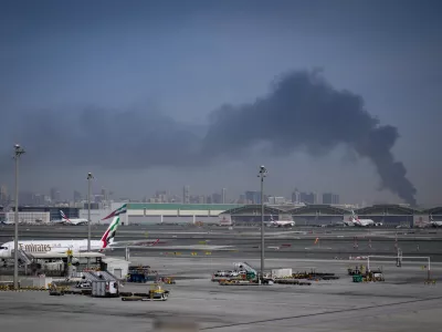 Emirates airplanes are parked at the Dubai International Airport after its closure in Dubai, United Arab Emirates, Sunday, March 1, 2026. (AP Photo/Altaf Qadri)