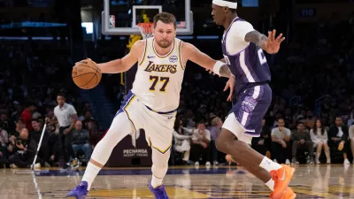 Los Angeles Lakers guard Luka Doncic drives to the basket as Sacramento Kings guard Daeqwon Plowden defends during the second half of an NBA basketball game in Los Angeles, Sunday, March 1, 2026. (AP Photo/Kyusung Gong)