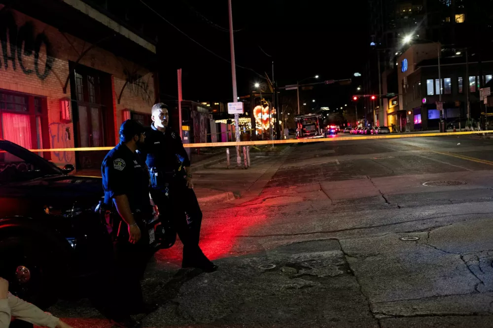 Austin police officers keep watch over the scene of a deadly mass shooting outside Buford's, a popular roadhouse-style bar in Austin, Texas, U.S. March 1, 2026. REUTERS/Nuri Vallbona