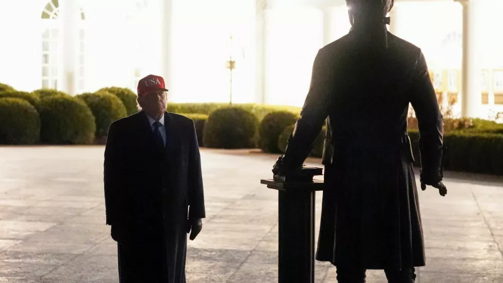 U.S. President Donald Trump looks at a newly installed statue of Thomas Jefferson, on returning to the White House, after Israel and the U.S. launched strikes on Iran, in Washington, D.C., U.S., March 1, 2026. REUTERS/Nathan Howard