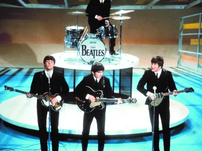 ** FILE **The Beatles perform on the CBS "Ed Sullivan Show" in New York, in this Feb. 9, 1964, file photo. From left, front, are Paul McCartney, George Harrison and John Lennon. Ringo Starr plays drums in the background. The Beatles' "Love" album is being released on Nov. 21, and is a thorough reinterpretation of their work. (AP Photo/FILE)------4 k