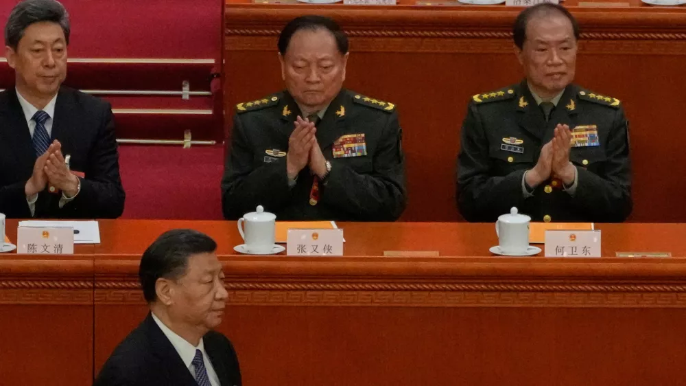 Chinese President Xi Jinping, bottom left, walks past then Vice Chairmen of China's Central Military Commission Zhang Youxia, top center, and He Weidong, top right, during a session of the National People's Congress (NPC) at the Great Hall of the People, in Beijing, China, March 12, 2023. (AP Photo/Andy Wong)