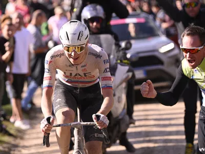 Slovenia's Tadej Pogacar competes during the men's Strade Bianche' (White Roads) cycling race from and to Siena, Italy, Saturday, March 2, 2024. (Fabio Ferrari/LaPresse via AP)