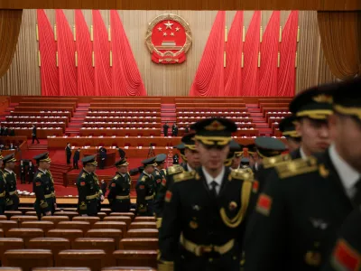 Military band members leave the venue following a rehearsal, before the opening session of the National People's Congress (NPC) at the Great Hall of the People in Beijing, China March 5, 2026. REUTERS/Florence Lo/Pool
