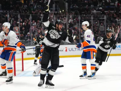Mar 5, 2026; Los Angeles, California, USA; LA Kings center Anze Kopitar (11) celebrates after a goal as New York Islanders defenseman Adam Pelech (3) and defenseman Carson Soucy (4)8 react in the second period at Crypto.com Arena. Mandatory Credit: Kirby Lee-Imagn Images