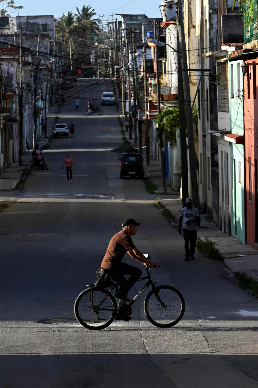 A man rides a bicycle on the street as Cuba brought its national electrical grid back online after the country had been largely without power for 16 hours in an outage that Energy Ministry officials linked to the oil blockade of Cuba imposed by the United States, in Havana, Cuba, March 5, 2026. REUTERS/Norlys Perez