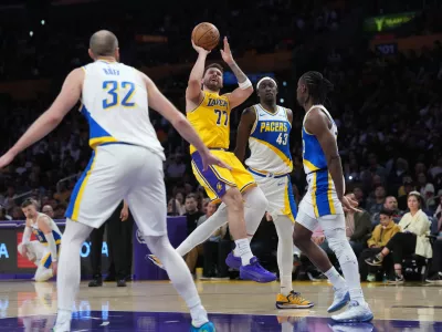 Mar 6, 2026; Los Angeles, California, USA; Los Angeles Lakers guard Luka Doncic (77) shoots the ball against Indiana Pacers forward Pascal Siakam (43), center Jay Huff (32) and guard Aaron Nesmith (23) in the first half at Crypto.com Arena. Mandatory Credit: Kirby Lee-Imagn Images