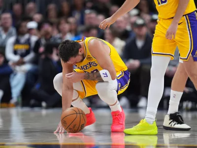 Los Angeles Lakers guard Luka Dončić reacts after getting hit in the face by the ball in the first half of an NBA basketball game against the Denver Nuggets Thursday, March 5, 2026, in Denver. (AP Photo/David Zalubowski)
