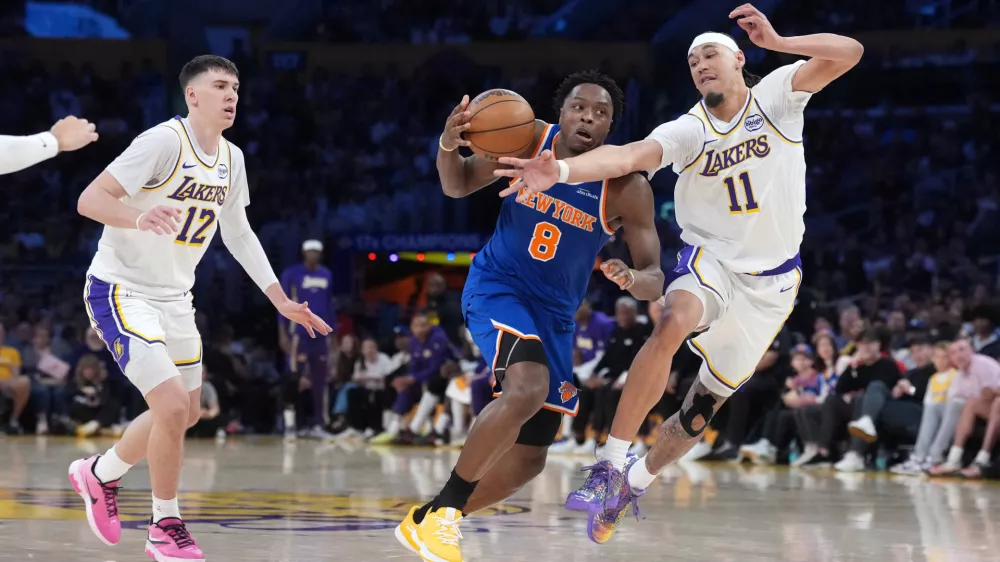 Mar 8, 2026; Los Angeles, California, USA; New York Knicks forward Og Anunoby (8) dribbles against Los Angeles Lakers center Jaxson Hayes (11) and forward Jake LaRavia (12) in the first half at Crypto.com Arena. Mandatory Credit: Kirby Lee-Imagn Images