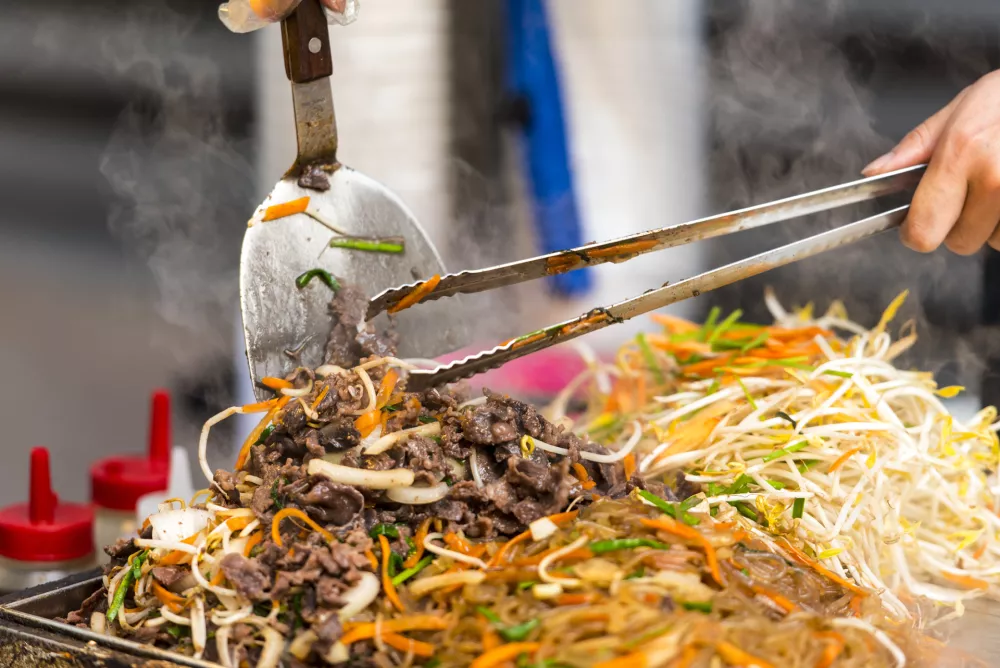 Asian street food - people cooking some food in Seoul - South Korea.