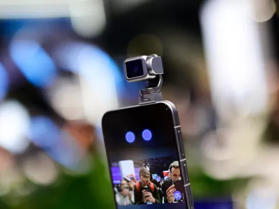 The 5 Honor Robot Phone is showcased at MWC 2026, featuring its signature motorized robotic camera arm. The device, which Honor calls a ''new species'' of smartphone, uses a self-developed micro-motor, 70% smaller than standard industry solutions, to deploy a 200MP camera on a three-axis gimbal. During the live demonstration, the robotic arm tracks subjects autonomously and responds to voice commands with human-like ''nods'' and ''shakes.'' This integration of embodied AI and mechanical motion allows the phone to perform cinematic pans, keep users perfectly centered during video calls, and even ''dance'' to music, marking a major leap in mobile videography and interactive hardware during the Mobile World Congress (MWC) in Barcelona, Spain, on March 5, 2026. (Photo by Joan Cros/NurPhoto)NO USE FRANCE