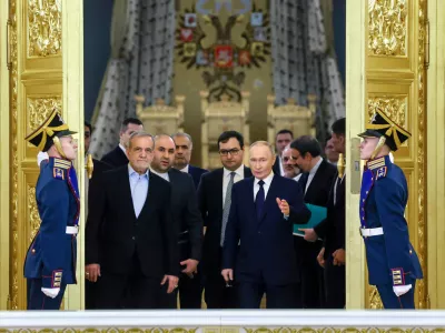 FILE - Iranian President Masoud Pezeshkian, center left, and Russian President Vladimir Putin, center right, arrive at a ceremony following their talks at the Kremlin in Moscow, Russia, on Jan. 17, 2025. (Vyacheslav Prokofyev, Sputnik, Kremlin Pool Photo via AP, File)