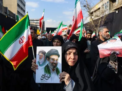A woman holds a placard with an image of Iran's new supreme leader Mojtaba Khamenei alongside late Iranian Supreme Leader Ayatollah Ali Khamenei, on the day of a gathering to support Mojtaba Khamenei, amid the U.S.-Israeli conflict with Iran, in Tehran, Iran, March 9, 2026. Majid Asgaripour/WANA (West Asia News Agency) via REUTERS ATTENTION EDITORS - THIS PICTURE WAS PROVIDED BY A THIRD PARTY