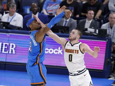 Mar 9, 2026; Oklahoma City, Oklahoma, USA; Oklahoma City Thunder guard Shai Gilgeous-Alexander (2) is hit in the face by Denver Nuggets guard Christian Braun (0) after shooting during the second half at Paycom Center. Mandatory Credit: Alonzo Adams-Imagn Images