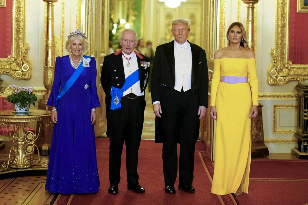 FILE PHOTO: Britain's King Charles and Queen Camilla stand with U.S. President Donald Trump and First Lady Melania Trump at the state banquet at Windsor Castle, in Windsor, Britain, September 17, 2025.  Aaron Chown/Pool via REUTERS/File Photo