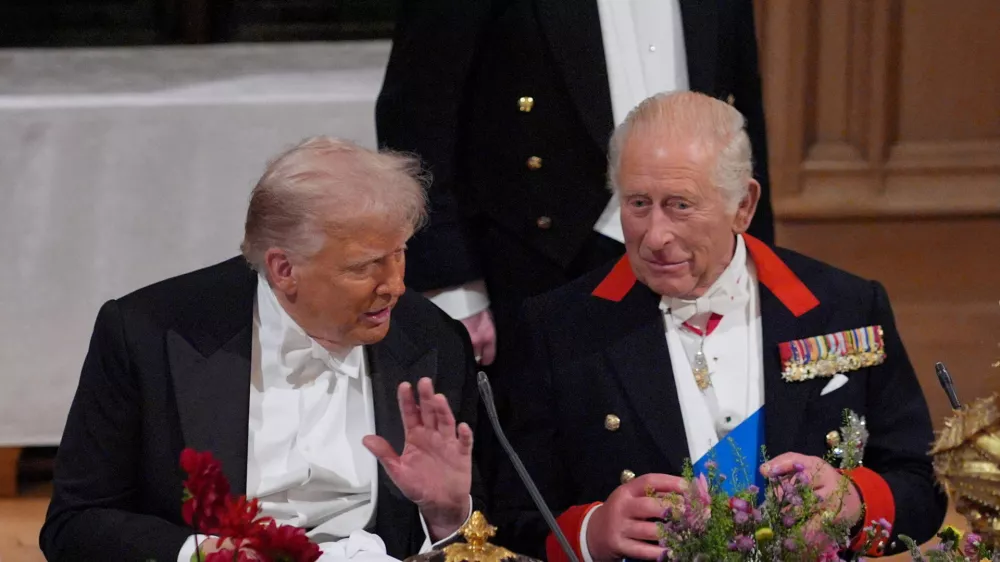 FILE PHOTO: US President Donald Trump and King Charles interact at the state banquet for the US President and First Lady Melania Trump at Windsor Castle, Berkshire, on day one of their second state visit to the UK, Wednesday September 17, 2025.  Yui Mok/Pool via REUTERS/File Photo