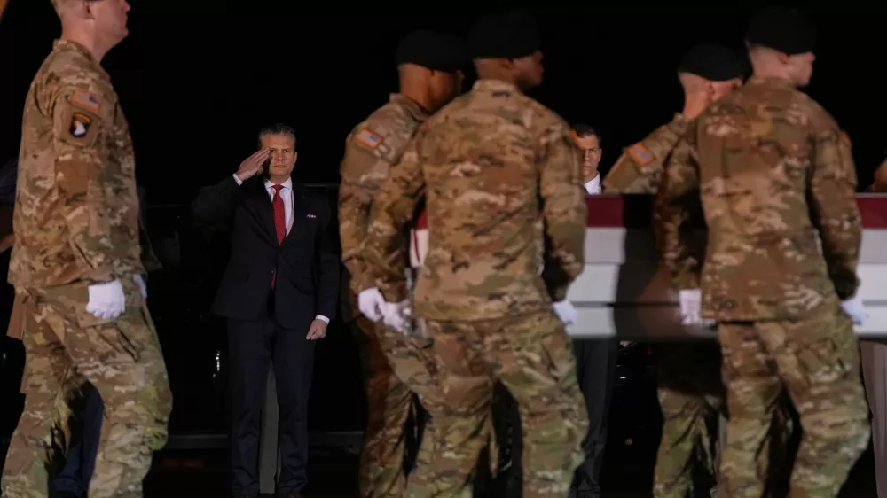 Defense Secretary Pete Hegseth salutes as an U.S. Army carry team moves the transfer case containing the remains of Sgt. Benjamin N. Pennington, 26, of Glendale, Ky., Monday March 9, 2026, at Dover Air Force Base, Del. (AP Photo/Julia Demaree Nikhinson)