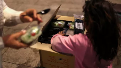 A girl gets food from a box, as her family was displaced following an escalation between Hezbollah and Israel amid the U.S.-Israeli conflict with Iran, in Beirut, Lebanon, March 10, 2026. REUTERS/Claudia Greco