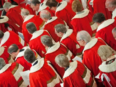 Members of the House of Lords wait for Britain's Queen Elizabeth II to address the House of Lords, during the State Opening of Parliament, at the Houses of Parliament, in Westminster, London on Tuesday May 25, 2010. Britain's Queen Elizabeth II set out the new coalition government's legislative programme on Tuesday in a ceremony of pomp and history following the closest general election for decades. (AP Photo/Leon Neal/Pool)