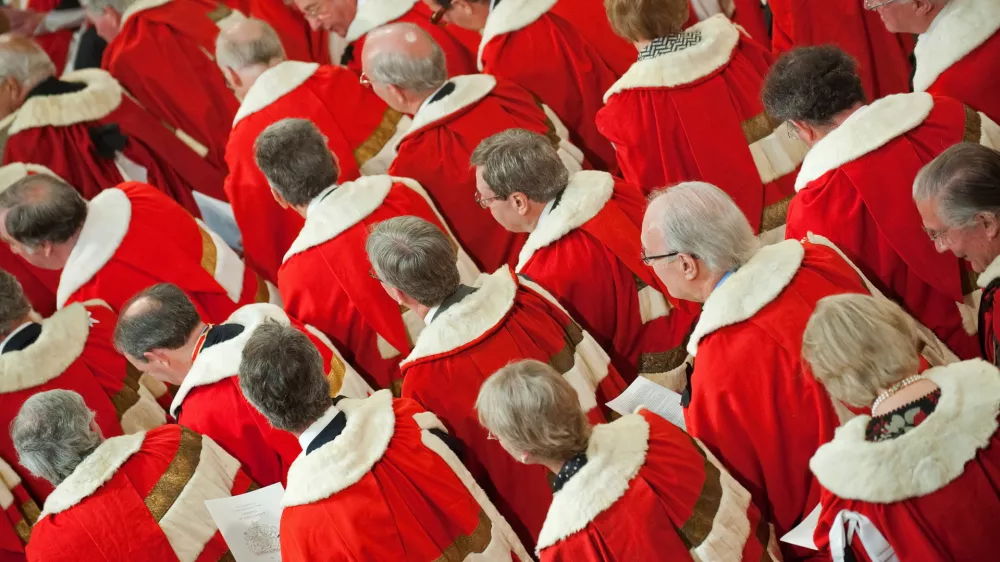 Members of the House of Lords wait for Britain's Queen Elizabeth II to address the House of Lords, during the State Opening of Parliament, at the Houses of Parliament, in Westminster, London on Tuesday May 25, 2010. Britain's Queen Elizabeth II set out the new coalition government's legislative programme on Tuesday in a ceremony of pomp and history following the closest general election for decades. (AP Photo/Leon Neal/Pool)