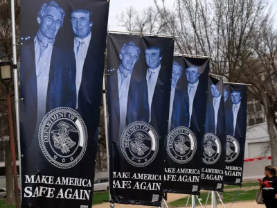 Banners with a photograph of President Donald Trump and Jeffrey Epstein are seen on the National Mall, Wednesday, March 11, 2026, in Washington. (AP Photo/Jose Luis Magana)