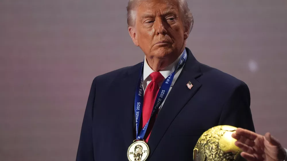 FILE - President Donald Trump stands on stage next to the FIFA World Cup after receiving the FIFA Peace Prize during the draw for the 2026 soccer World Cup at the Kennedy Center in Washington, Dec. 5, 2025. (AP Photo/Jacquelyn Martin, File)