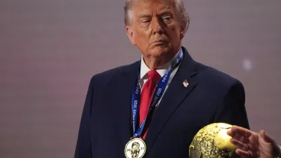 FILE - President Donald Trump stands on stage next to the FIFA World Cup after receiving the FIFA Peace Prize during the draw for the 2026 soccer World Cup at the Kennedy Center in Washington, Dec. 5, 2025. (AP Photo/Jacquelyn Martin, File)
