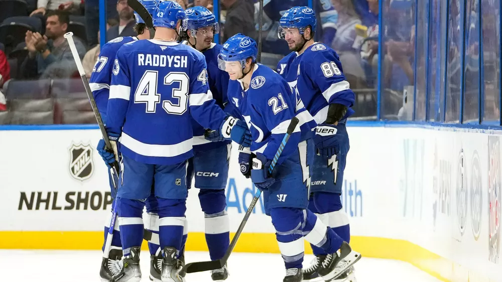 Tampa Bay Lightning center Brayden Point (21) celebrates his goal against the Detroit Red Wings with right wing Nikita Kucherov (86) and defenseman Darren Raddysh (43) during the third period of an NHL hockey game Thursday, March 12, 2026, at Benchmark International Arena in Tampa, Fla. (AP Photo/Chris O'Meara)