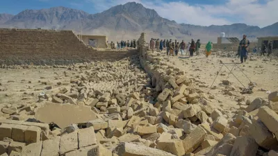 People stand near a house damaged in what the Taliban said was a Pakistani air strike on the outskirts of Kabul, Afghanistan, March 13, 2026. Picture taken with a mobile phone. REUTERS/Sayed Hassib