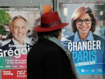 FILE PHOTO: A man looks at posters of Paris mayoral election candidates Emmanuel Gregoire, Socialist party candidate and head of the "left-wing coalition" list (La Gauche unie) and Rachida Dati, supported by Les Republicains (LR) and the MoDem parties, are seen on electoral campaign panel boards in Paris, France, March 6, 2026. REUTERS/Stephane Mahe/File Photo
