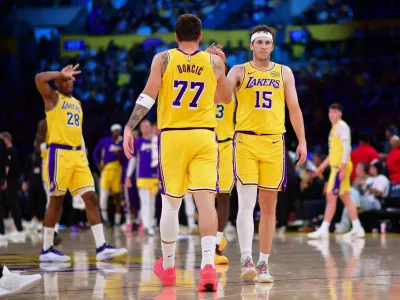 Mar 12, 2026; Los Angeles, California, USA; Los Angeles Lakers guard Luka Doncic (77) and guard Austin Reaves (15) react during the second half at Crypto.com Arena. Mandatory Credit: Gary A. Vasquez-Imagn Images