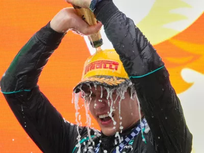 Race winner Mercedes driver Andrea Kimi Antonelli of Italy pours champagne on himself as he celebrates on the podium after the Chinese Formula One Grand Prix at the Shanghai International Circuit in Shanghai, China, Sunday, March 15, 2026. (AP Photo/Vincent Thian)