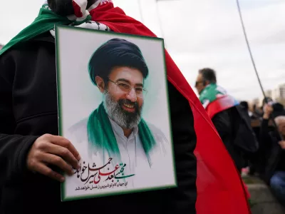 A demonstrator holds a portrait of the Ayatollah Mojtaba Khamenei during the Al Quds day in London, England, Sunday, March 15, 2026. (AP Photo/Alberto Pezzali)