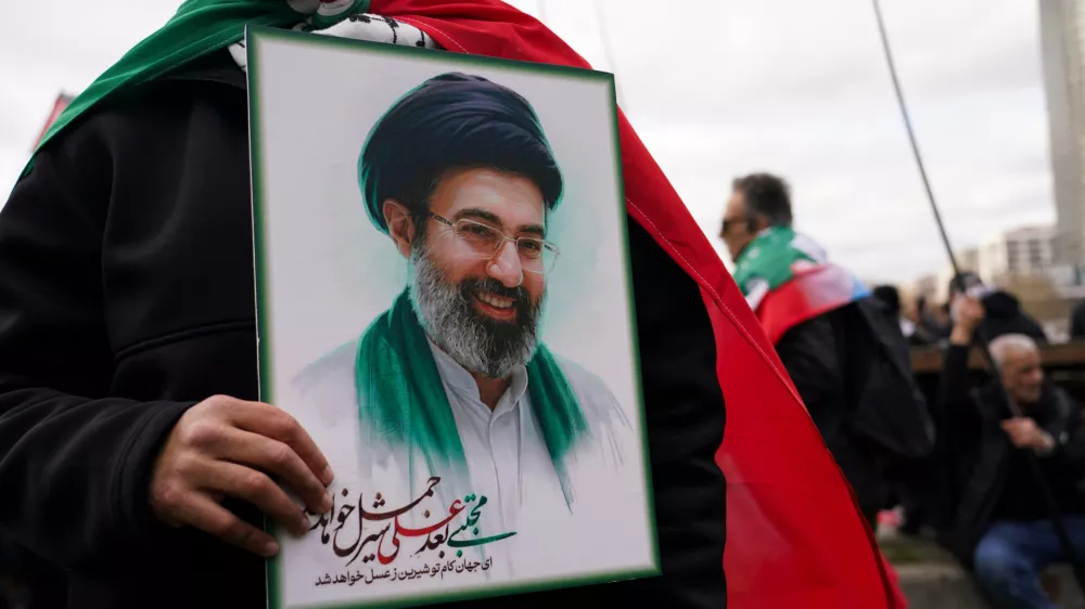 A demonstrator holds a portrait of the Ayatollah Mojtaba Khamenei during the Al Quds day in London, England, Sunday, March 15, 2026. (AP Photo/Alberto Pezzali)