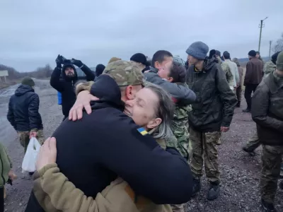 A woman embraces a Ukrainian prisoner of war (POWs) after a swap, amid Russia's attack on Ukraine, in an unknown location, Ukraine December 31, 2022. Head of Ukraine's Presidential Office Andriy Yermak via Telegram/Handout via REUTERS ATTENTION EDITORS - THIS IMAGE HAS BEEN SUPPLIED BY A THIRD PARTY. NO RESALES NO ARCHIVE.