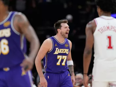Los Angeles Lakers' Luka Doncic (77) celebrates after making a basket against the Houston Rockets during the second half of an NBA basketball game Wednesday, March 18, 2026, in Houston. (AP Photo/David J. Phillip)
