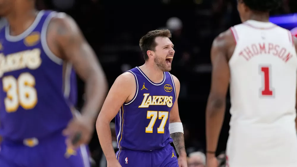 Los Angeles Lakers' Luka Doncic (77) celebrates after making a basket against the Houston Rockets during the second half of an NBA basketball game Wednesday, March 18, 2026, in Houston. (AP Photo/David J. Phillip)