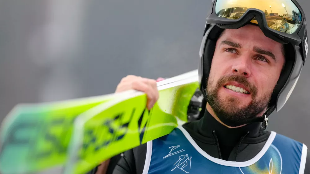 Johannes Rydzek, of Germany, makes his way to the ramp during the Nordic Combined Individual Gundersen Normal Hill/10km competition at the 2026 Winter Olympics, in Predazzo, Italy, Wednesday, Feb. 11, 2026. (AP Photo/Evgeniy Maloletka)