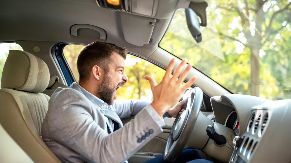 Really angry driver behind the steering wheel cannot keep his calmness