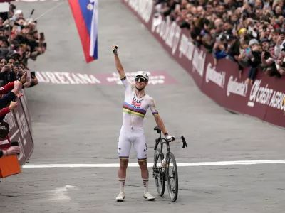Tadej Pogacar of Team UAE Emirates celebrates winning the Strade Bianche (White Roads), a 203 km one day cycling race from and to Siena, Italy, Saturday March 7, 2026. (Fabio Ferrari/LaPresse via AP)