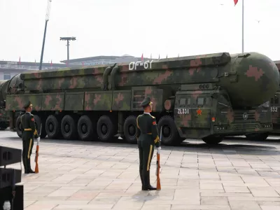 Members of the People's Liberation Army stand as the strategic strike group displays DF-61 nuclear missiles during a military parade to mark the 80th anniversary of the end of World War Two, in Beijing, China, September 3, 2025. REUTERS/Tingshu Wang