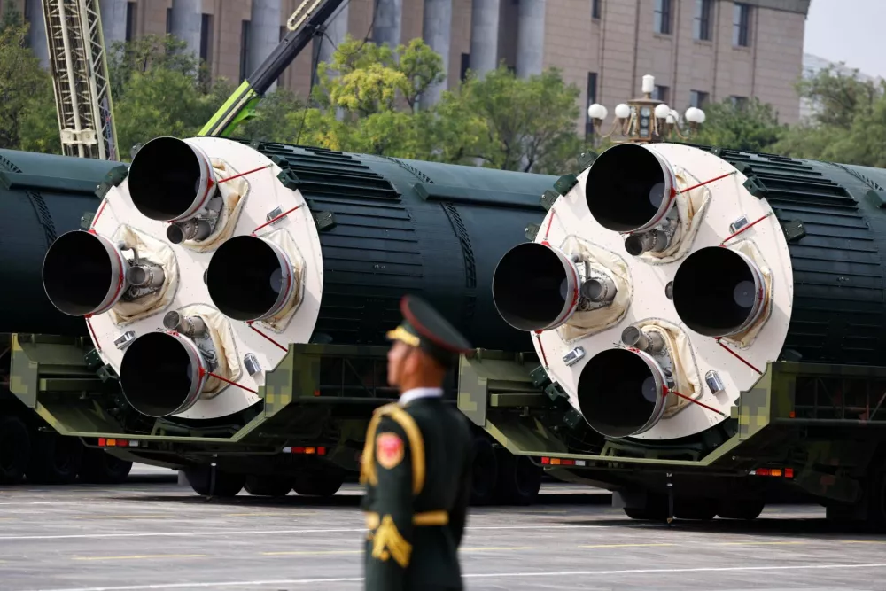 A member of the People's Liberation Army stands as the strategic strike group displays DF-5C nuclear missiles during a military parade to mark the 80th anniversary of the end of World War Two, in Beijing, China, September 3, 2025. REUTERS/Tingshu Wang