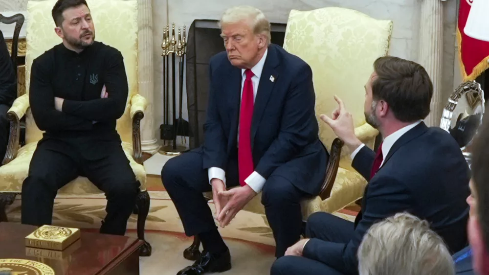 FILE - Vice President JD Vance, right, speaks with Ukrainian President Volodymyr Zelenskyy, left, as President Donald Trump listens in the Oval Office at the White House, Feb. 28, 2025, in Washington. (AP Photo/ Mystyslav Chernov, File)