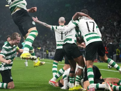 Sporting CP players celebrate after Sporting's Maximiliano Araujo scored his side's fourth goal during a Champions League round of 16 second leg soccer match between Sporting CP and Bodo Glimt in Lisbon, Portugal, Tuesday, March 17, 2026. (AP Photo/Ana Brigida)