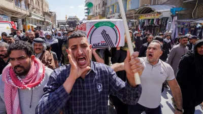 Iraqis attend the funeral of an Iranian-backed Popular Mobilization Forces fighter killed in recent airstrikes on Qaim, Tuesday, March 17, 2026. in Najaf, Iraq. (AP Photo/Anmar Khalil)