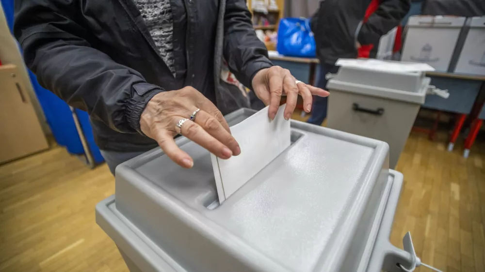 A woman casts her vote at a local polling station during the general election and national referendum on the child protection law in Budapest, Hungary, Sunday, April 3, 2022. (Gyorgy Varga/MTI via AP)