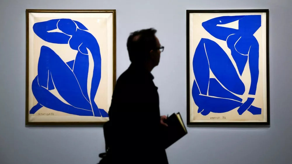 A man walks past the paintings "Blue Nude II, 1952" and "Blue Nude III, 1952" by painter Henri Matisse (1869-1954) during a press visit of the exhibition "Matisse, 1941 - 1954" at the Grand Palais in Paris, France, March 23, 2026. REUTERS/Sarah Meyssonnier