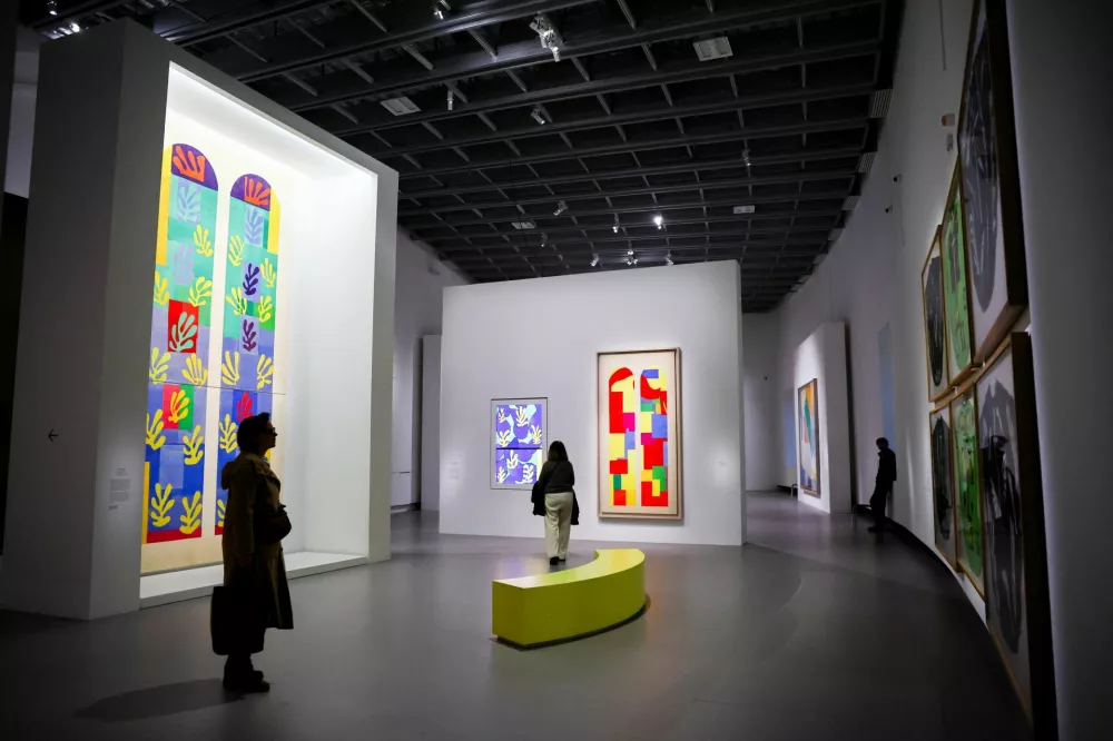 A woman looks at paintings by painter Henri Matisse (1869-1954) during a press visit of the exhibition "Matisse, 1941 - 1954" at the Grand Palais in Paris, France, March 23, 2026. REUTERS/Sarah Meyssonnier