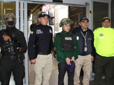 Colombian police officers escort a man identified as Angel Esteban Aguilar, a leader of Ecuador's Los Lobos crime group, after his arrest, who is wanted in connection with the 2023 assassination of Ecuadorean presidential candidate Fernando Villavicencio, at the international airport El Dorado in Bogota, Colombia, March 18, 2026. Colombian Migration/Handout via REUTERS THIS IMAGE HAS BEEN SUPPLIED BY A THIRD PARTY. MANDATORY CREDIT. NO RESALES. NO ARCHIVES.