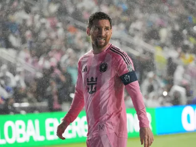 Inter Miami forward Lionel Messi (10) walks to kick a corner kick in heavy rain during the first half of a CONCACAF Champions Cup Round of 16 soccer match against Nashville, Wednesday, March 18, 2026, in Fort Lauderdale, Fla. (AP Photo/Marta Lavandier)
